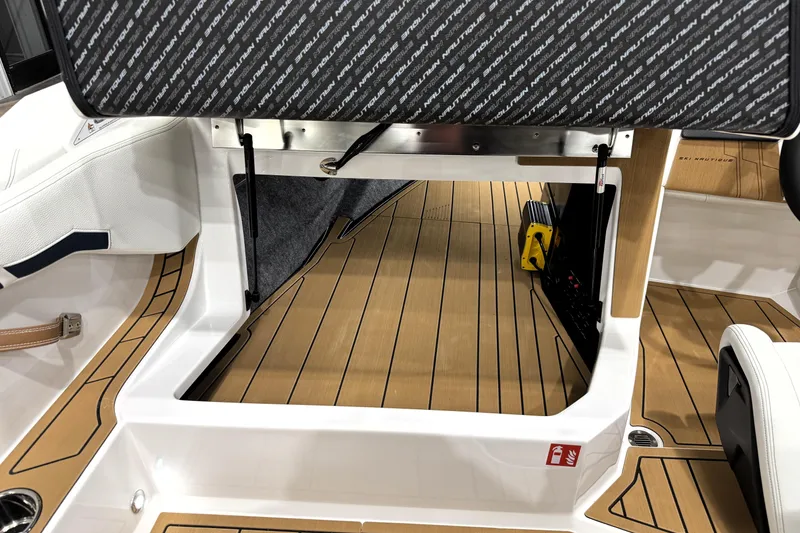 Slide: The Image of 2026 Nautique Ski Nautique interior with teak flooring and branded upholstery. - 14