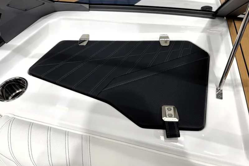 Slide: The Image of 2026 Nautique Ski Nautique interior detail with sleek black panel and cup holder. - 16