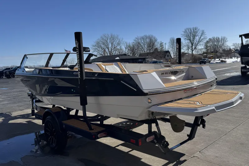 Slide: The Image of 2026 Nautique Ski Nautique boat on trailer, sunny day, outdoor setting. - 3