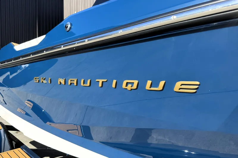 Slide: The Image of 2026 Nautique Ski Nautique boat with blue exterior and gold lettering. - 5