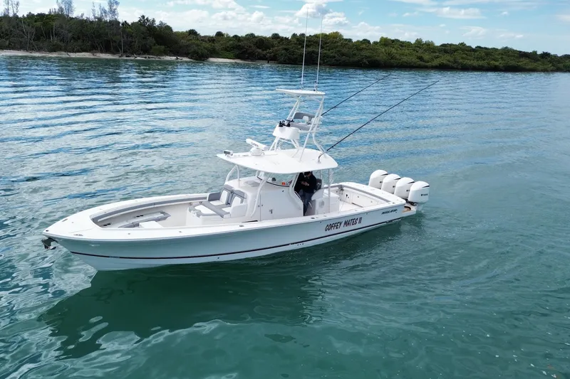 Slide: The Image of 2018 Regulator 41 boat on calm water, featuring triple outboard engines. - 4