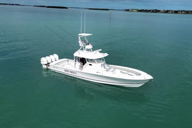 Slide: The Image of 2018 Regulator 41 boat on calm turquoise water, equipped with multiple outboard engines. - 5