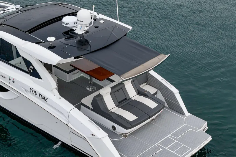 Slide: The Image of 2022 Cruisers 42 GLS luxury yacht on calm water, showcasing sleek design and spacious deck. - 19