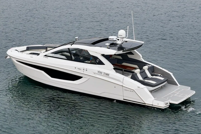 Slide: The Image of 2022 Cruisers 42 GLS luxury boat with spacious seating on calm water. - 22