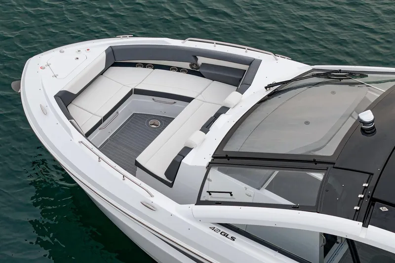 Slide: The Image of Interior view of 2022 Cruisers 42 GLS yacht, featuring modern seating and wooden table. - 25