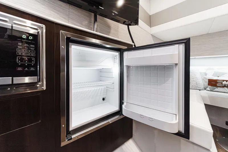 Slide: The Image of 2022 Cruisers 42 GLS yacht with spacious deck and seating on calm water. - 3