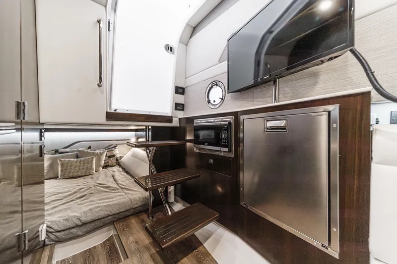 Slide: The Image of 2022 Cruisers 42 GLS yacht interior with open mini fridge and microwave. - 32