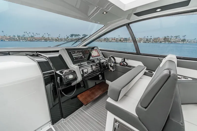 Slide: The Image of Luxurious interior of 2022 Cruisers 42 GLS yacht with white seating and wooden table. - 38