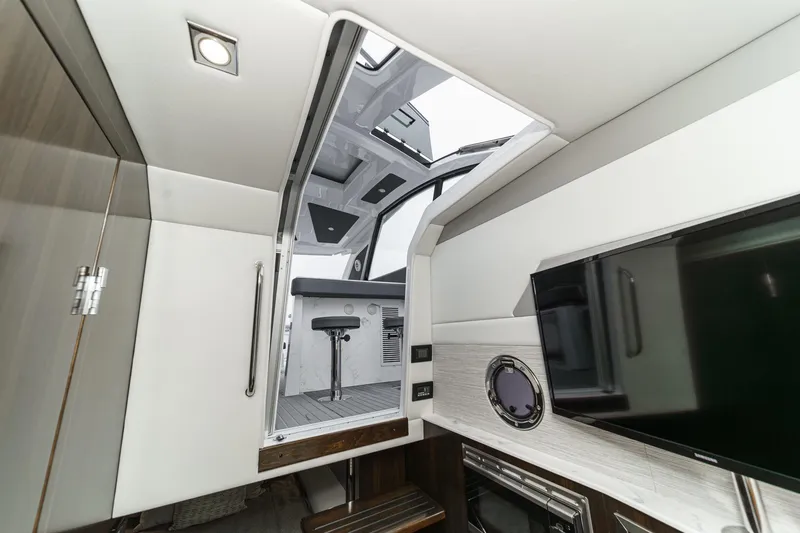 Slide: The Image of Seakeeper 6 gyroscope in 2022 Cruisers 42 GLS engine room with blue hoses. - 51