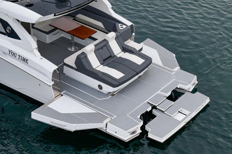 Slide: The Image of 2022 Cruisers 42 GLS yacht with spacious deck and seating, docked at Alamitos Bay. - 6
