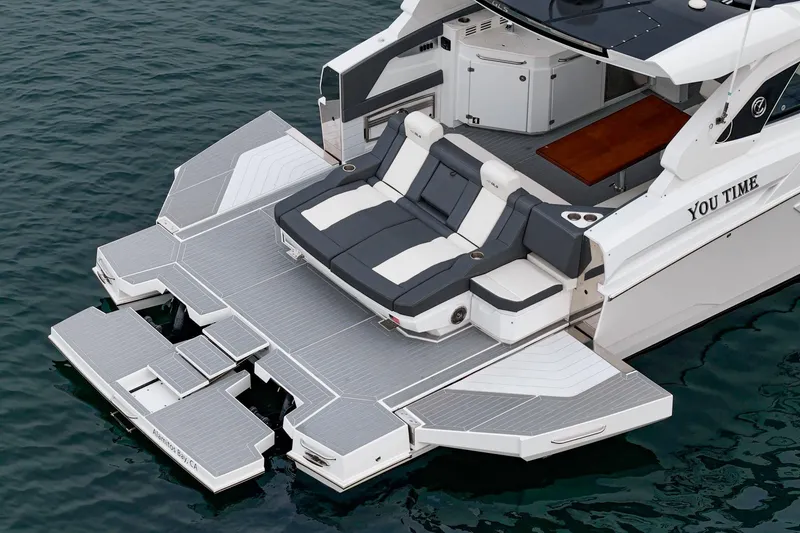 The Image of 2022 Cruisers 42 GLS yacht with spacious deck and luxurious seating on water. - 0