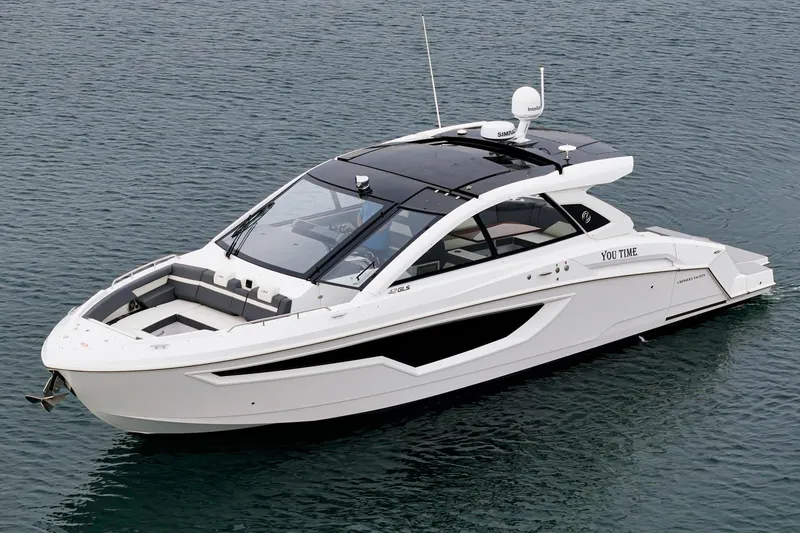 Slide: The Image of 2022 Cruisers 42 GLS luxury yacht with sunshade and seating on calm water. - 16