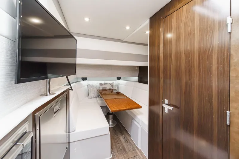 Slide: The Image of Luxurious 2022 Cruisers 42 GLS yacht interior with elegant seating and wooden table. - 35