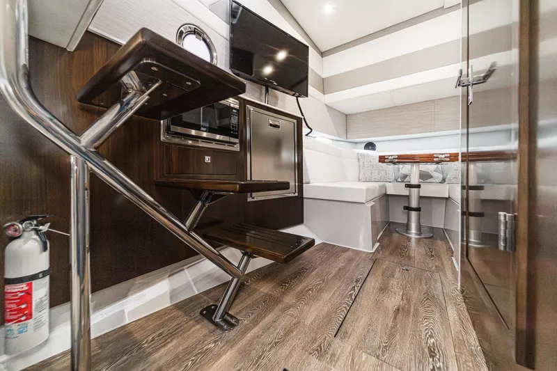 Slide: The Image of 2022 Cruisers 42 GLS yacht cockpit with modern controls and waterfront view. - 37