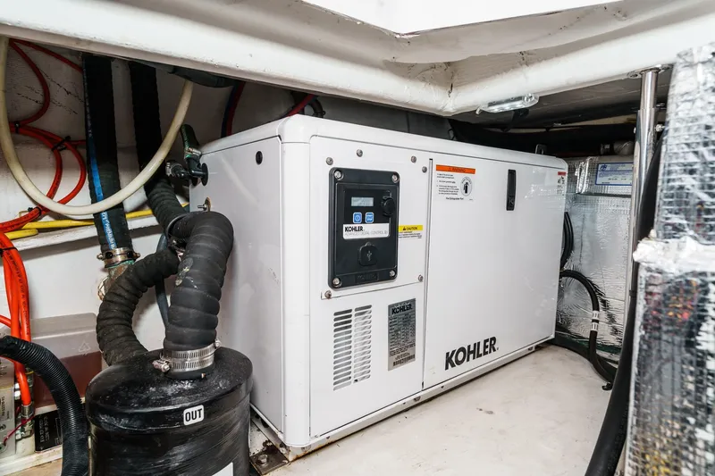 Slide: The Image of Luxurious 2022 Cruisers 42 GLS yacht interior with sleek seating and elegant wooden table. - 43