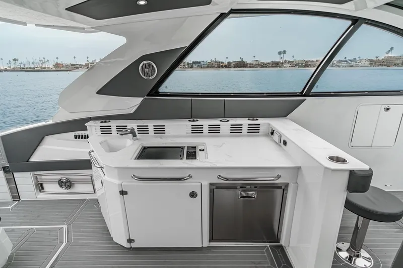Slide: The Image of 2022 Cruisers 42 GLS yacht interior with modern helm, seating, and panoramic windows. - 46