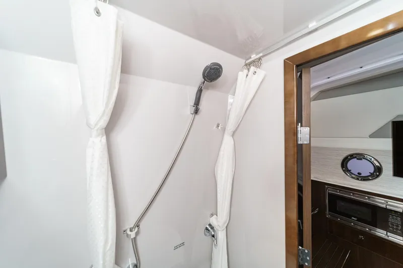 Slide: The Image of Interior view of 2022 Cruisers 42 GLS yacht helm with modern navigation systems. - 48