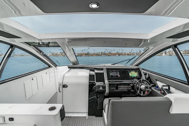 Slide: The Image of Helm of 2022 Cruisers 42 GLS with dual Simrad displays and navigation controls. - 49