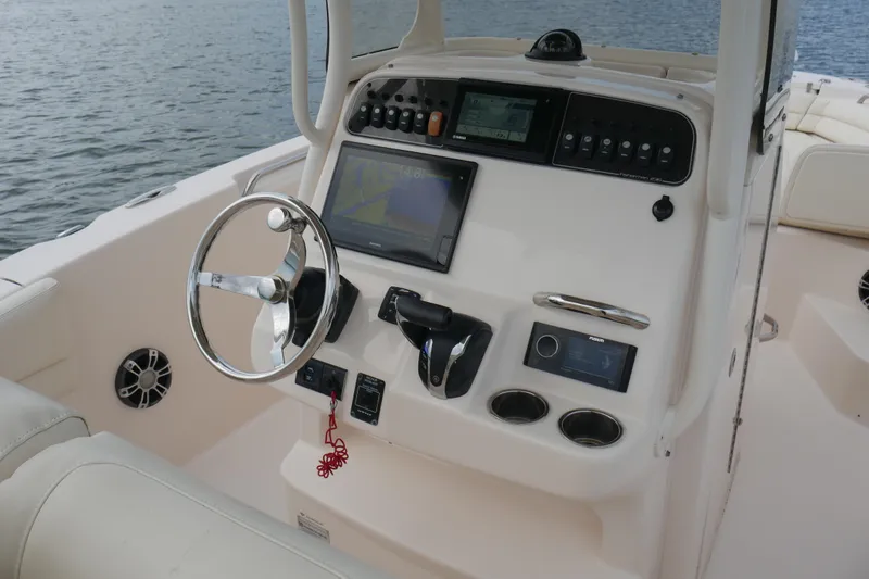 Slide: The Image of 2021 Grady-White Fisherman 236 boat console with steering wheel and navigation system. - 10