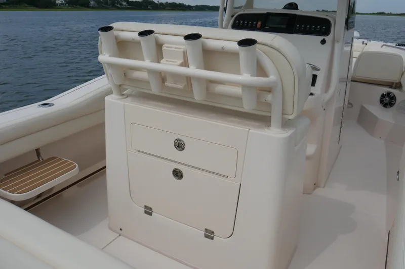 Slide: The Image of 2021 Grady-White Fisherman 236 boat interior with rod holders and storage compartments. - 12