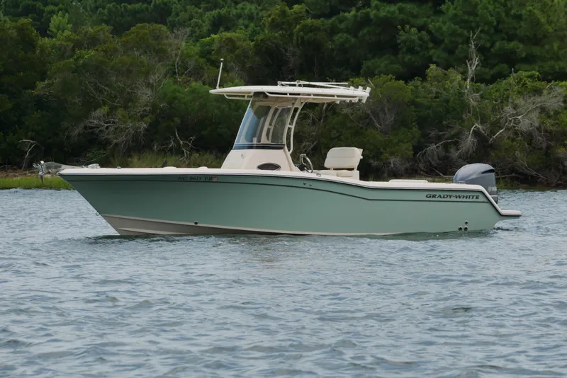 Slide: The Image of 2021 Grady-White Fisherman 236 boat on water, surrounded by lush greenery. - 3