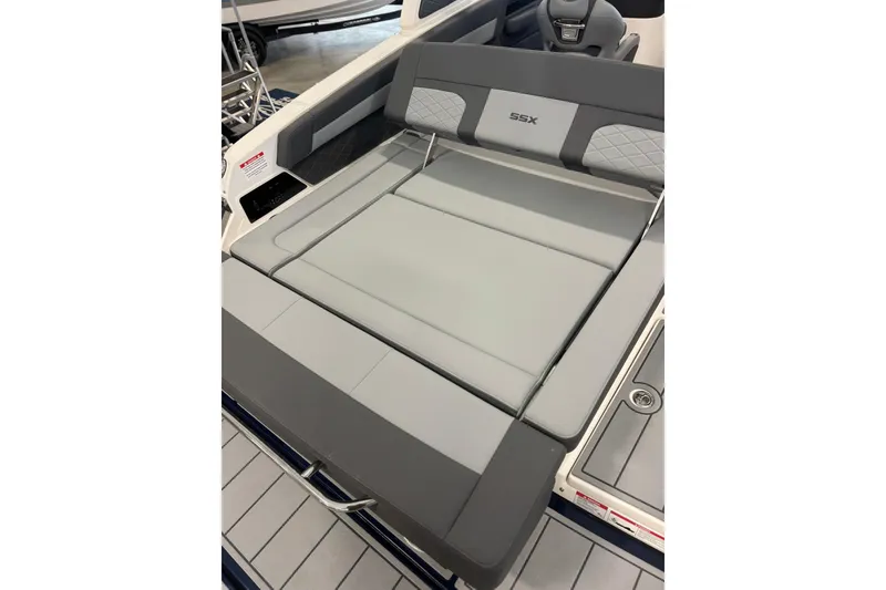 Slide: The Image of 2026 Chaparral SSX 6 boat interior with sleek gray seating and modern design. - 12