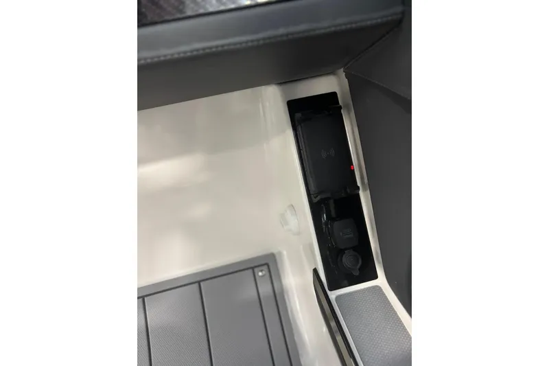 Slide: The Image of 2026 Chaparral SSX 6 interior detail with wireless charging pad and USB ports. - 25