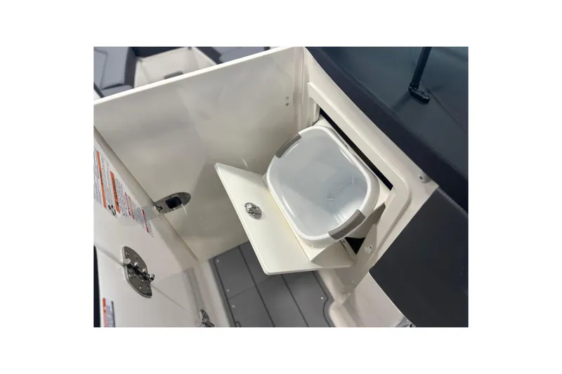 Slide: The Image of 2026 Chaparral SSX 6 boat interior storage compartment with built-in trash bin. - 28