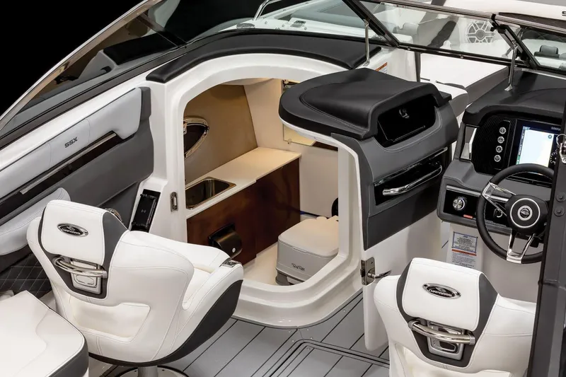 Slide: The Image of 2026 Chaparral SSX 6 boat on trailer in showroom, featuring boarding ladder. - 4