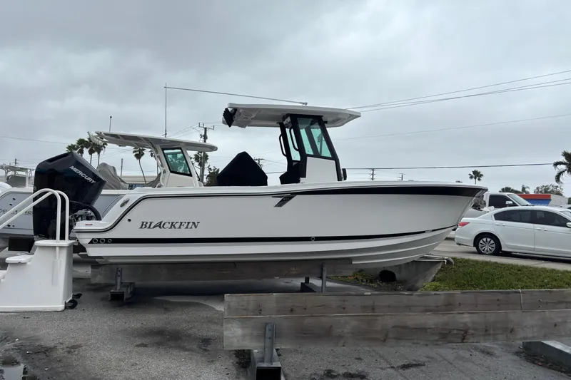 The Image of 2025 Blackfin 252 CC boat on display, overcast sky background. - 1