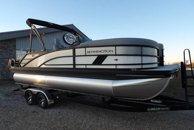 The Image of 2026 Bennington M Swingback 22 MSB pontoon boat on trailer at marina. - 1