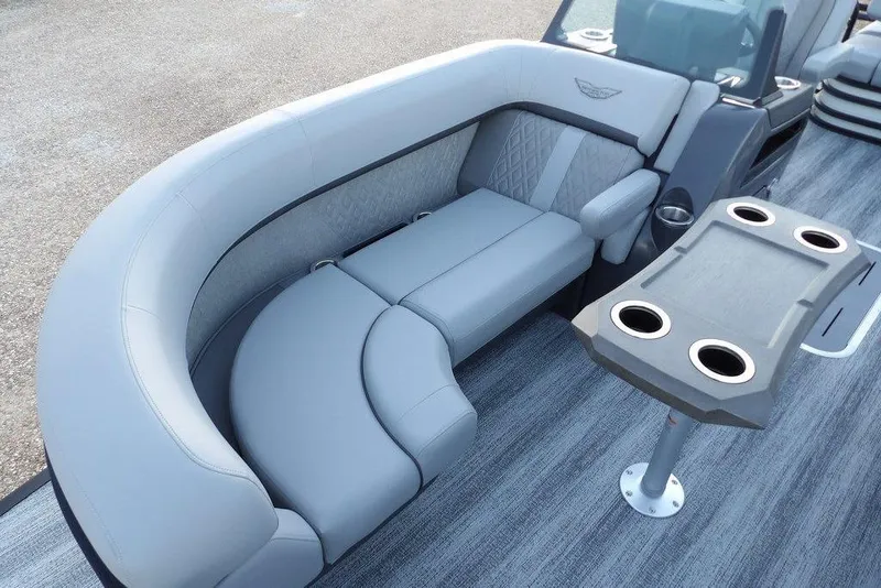 Slide: The Image of 2026 Bennington M Swingback 22 MSB boat interior with plush seating and cupholder table. - 11