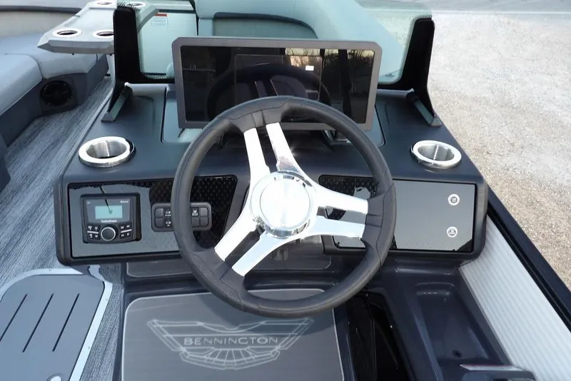 Slide: The Image of 2026 Bennington M Swingback 22 MSB dashboard with steering wheel and controls. - 22