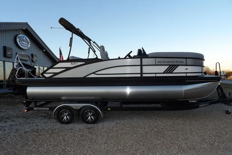 Slide: The Image of 2026 Bennington M Swingback 22 MSB pontoon boat on trailer at dealership. - 4