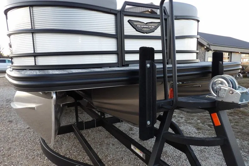 Slide: The Image of 2026 Bennington M Swingback 22 MSB pontoon boat on trailer, close-up view. - 44