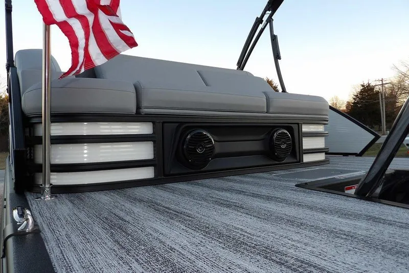 Slide: The Image of 2026 Bennington M Swingback 22 MSB pontoon boat with American flag and stylish seating. - 46