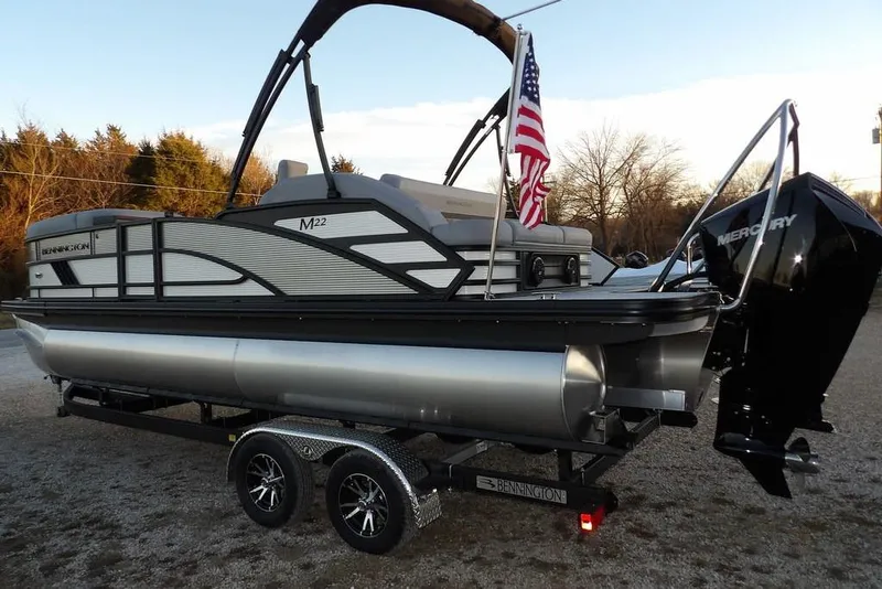 Slide: The Image of 2026 Bennington M Swingback 22 MSB pontoon boat with Mercury engine and American flag. - 9