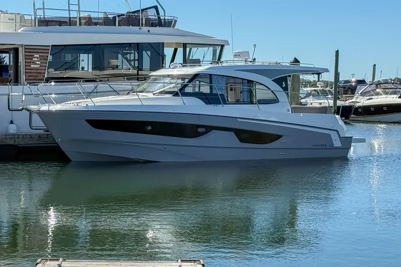 The Image of 2026 Beneteau Antares 11 yacht docked in a marina, side view. - 1
