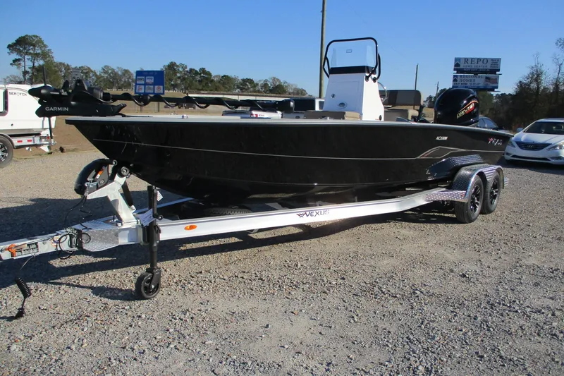 Slide: The Image of 2026 Vexus ACX2210 boat on trailer, black exterior, parked outdoors. - 1
