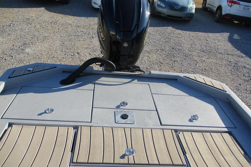 Slide: The Image of 2026 Vexus ACX2210 boat deck with motor, parked on gravel lot. - 13