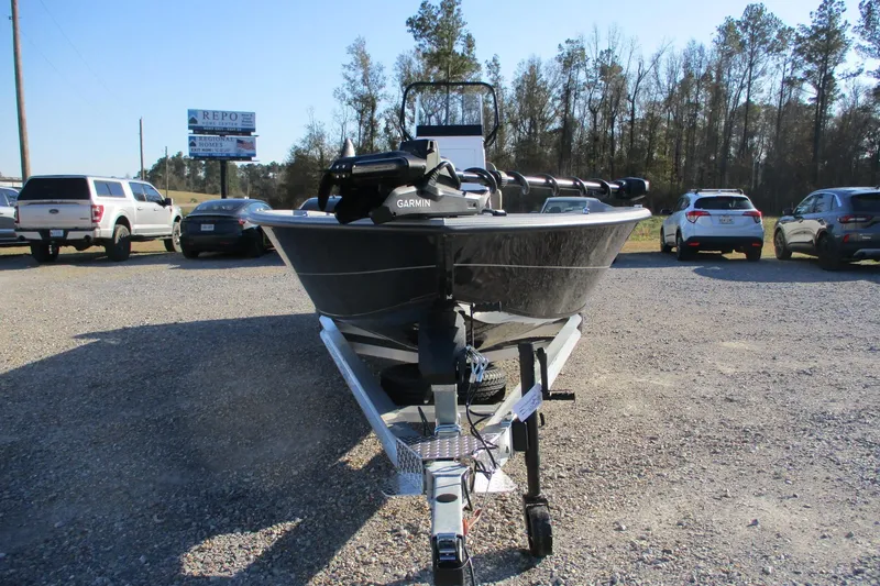 Slide: The Image of 2026 Vexus ACX2210 boat on trailer in parking lot, surrounded by cars and trees. - 5