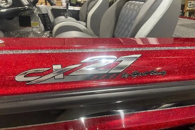 Slide: The Image of 2026 Caymas CX 21 PRO boat interior with red metallic finish and logo detail. - 3