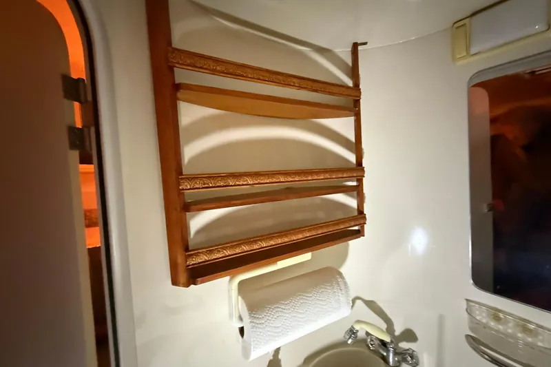 Slide: The Image of Interior of 1995 Carver 250 Express boat with wooden towel rack and sink. - 11