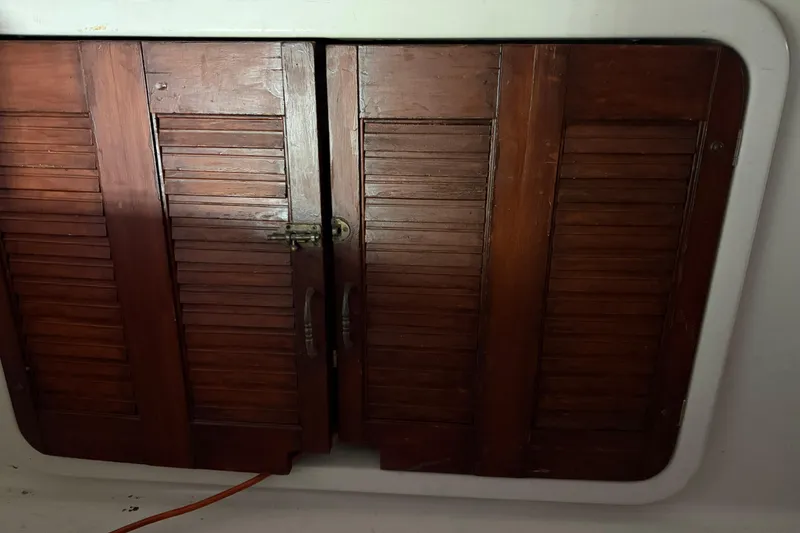 Slide: The Image of Wooden cabinet doors on a 1995 Carver 250 Express boat interior. - 20