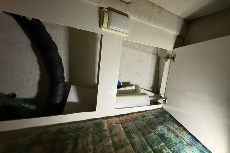 Slide: The Image of Interior view of a 1995 Carver 250 Express boat storage compartment. - 10