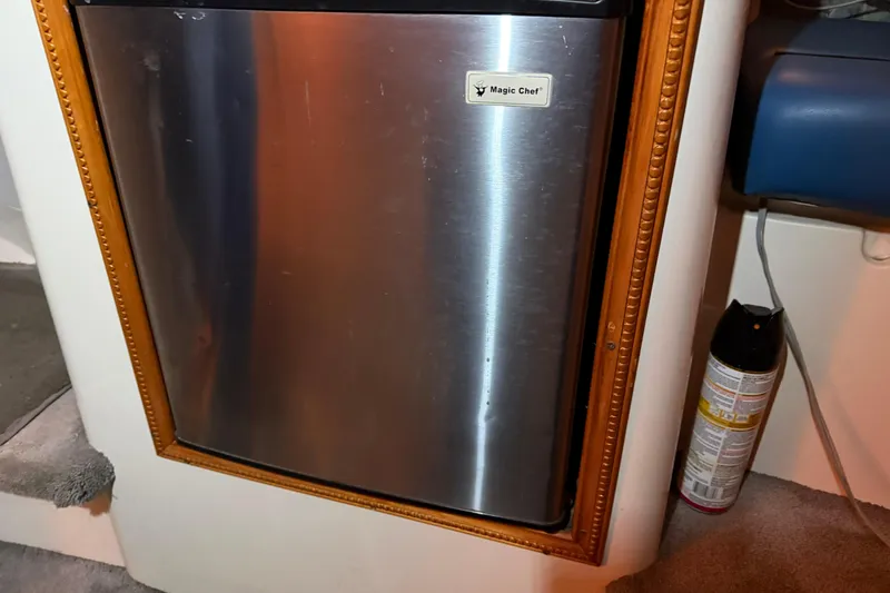 Slide: The Image of Magic Chef fridge in 1995 Carver 250 Express boat interior, framed with wood trim. - 13