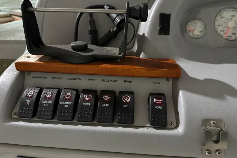 Slide: The Image of Control panel of a 1995 Carver 250 Express boat with labeled switches. - 16