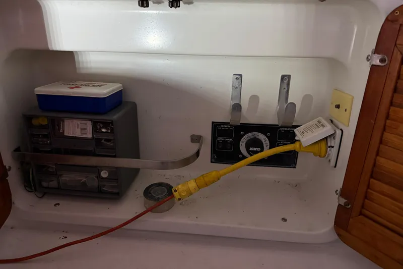 Slide: The Image of Electrical panel and storage inside a 1995 Carver 250 Express boat. - 19