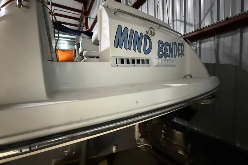 Slide: The Image of 1995 Carver 250 Express boat named "Mind Bender" in storage facility. - 22