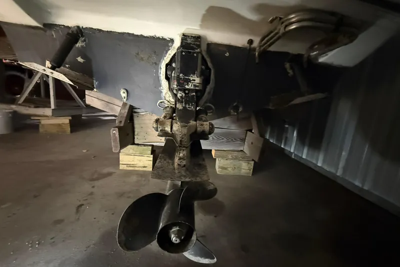 Slide: The Image of 1995 Carver 250 Express boat propeller and stern view in storage. - 23